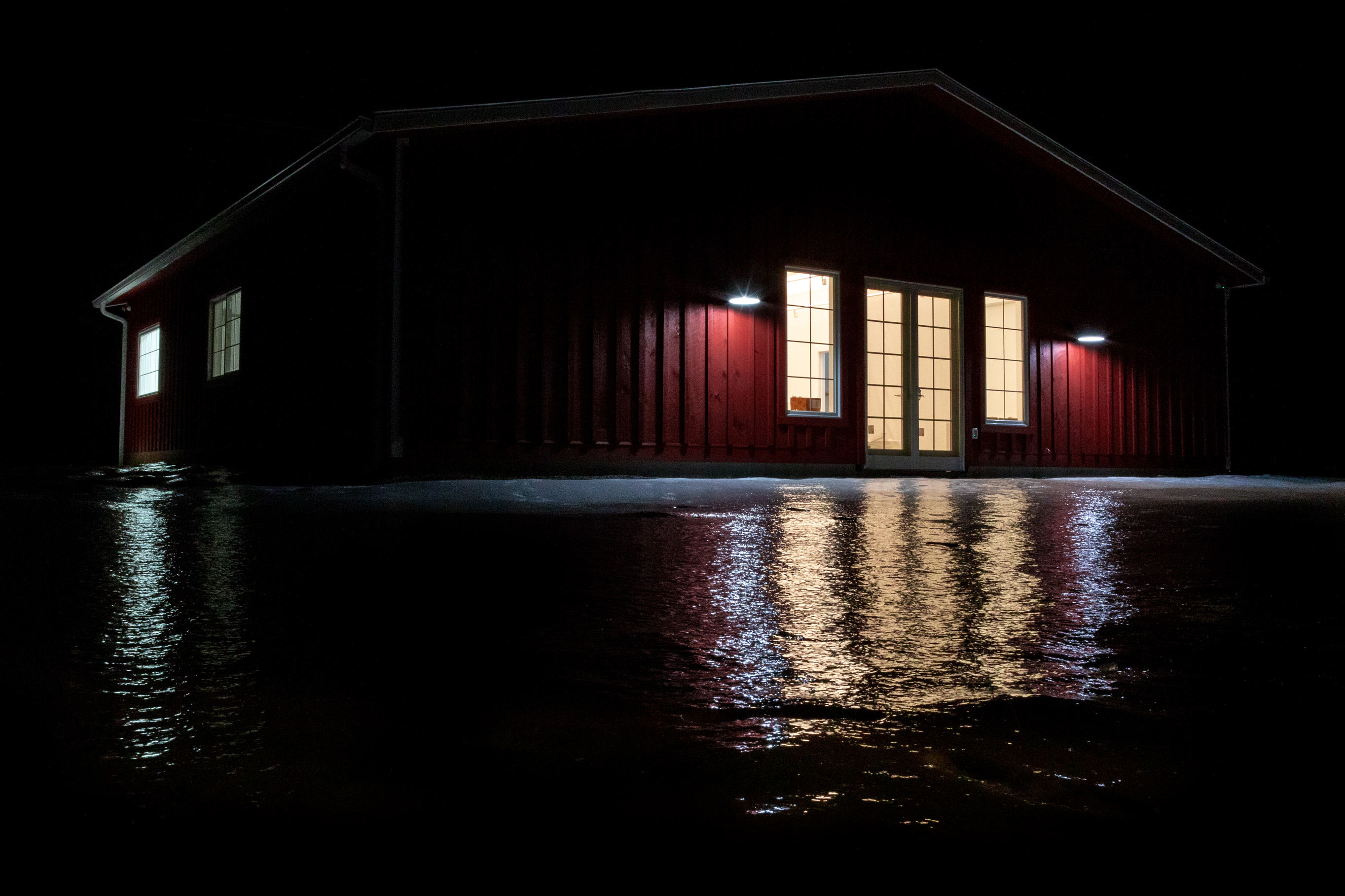Red studio reflected in water at night